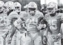  ?? STAFF PHOTO BY C.B. SCHMELTER ?? Tennessee defensive back Todd Kelly Jr. (24) gets pumped up during warmups before the kickoff of a recent game. Kelly said he is proud to be a Volunteer heading into what may be his last game as a Vol.