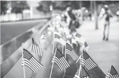  ??  ?? Small American flags are placed in all 2,983 names on the 9/11 Memorial in the Manhattan borough of New York City. — AFP photo