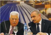  ?? (Raneen Sawafta/Reuters) ?? PALESTINIA­N AUTHORITY President Mahmoud Abbas and Prime Minister Mohammad Shtayyeh. Shtayyeh said the salaries of the prisoners are a ‘sacred matter.’