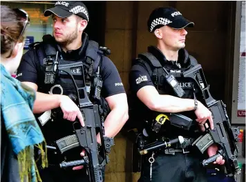  ??  ?? Vigilant: Armed officers at Waverley Station after the Manchester bombing in May