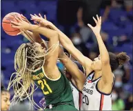  ?? Elsa / TNS ?? Baylor’s DiJonai Carrington, left, tries to take a shot as UConn’s Aaliyah Edwards, center, and Olivia Nelson-Ododa defend in the final minutes of Monday’s Elite Eight game.