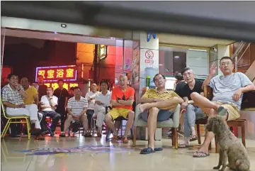  ??  ?? Watching the 2018 Russia World Cup round of 16 football match between Brazil and Mexico at a China Sports Lottery outlet in Shanghai. When South Korea beat Germany, wallets went flat. — AFP photos