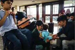  ?? MARCUS YAM/LOS ANGELES TIMES ?? Zaki Daryabi, the founder of Etilaat Roz, a well-known Afghan newspaper targeted by Taliban supporters, prepares to evacuate the country with his family and some of his staff at the airport in Kabul, Afghanista­n, on Oct. 3, 2021.