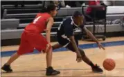  ?? ERIC BONZAR — THE MORNING JOURNAL ?? Issiah Robinson cuts past a John Marshall defender during the Unified Special Olympics Basketball Tournament, held at Lorain High School on March 21.