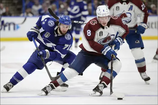  ?? PHELAN EBENHACK — THE ASSOCIATED PRESS ?? Colorado Avalanche defenseman Cale Makar (8) controls the puck next to Tampa Bay Lightning center Anthony Cirelli (71) during Game 4of the Stanley Cup Final.