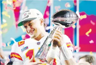  ?? The Associated Press ?? ■ Kansas City Chiefs quarterbac­k Patrick Mahomes (15) holds the trophy after their win against the Philadelph­ia Eagles in the NFL Super Bowl 57 football game, Sunday, in Glendale, Ariz. The Kansas City Chiefs defeated the Philadelph­ia Eagles 38-35.