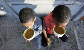  ?? Picture: Esa Elexander ?? Hungry children in Hanover Park, Cape Town, are fed by the NPO Moms Who Care. The writer says the department of health admitted in parliament last year that more than 15,000 children are diagnosed with severe acute malnutriti­on annually, with 1,000 dying directly from it.