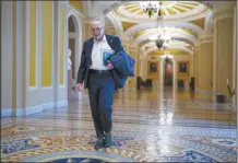  ?? AP photo ?? Senate Majority Leader Chuck Schumer, D-N.Y., arrives as the Senate prepares to take a procedural vote on an emergency spending package that would provide military aid to Ukraine and Israel, replenish U.S. weapons systems and provide food, water and other humanitari­an aid to civilians in Gaza, at the Capitol in Washington, on Sunday.