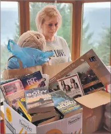  ??  ?? Volunteer Fay Harris sorting through the many donations.