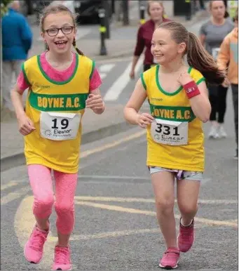  ??  ?? Two of Boyne AC’s juvenile athletes enjoying the Midsummer 5k.