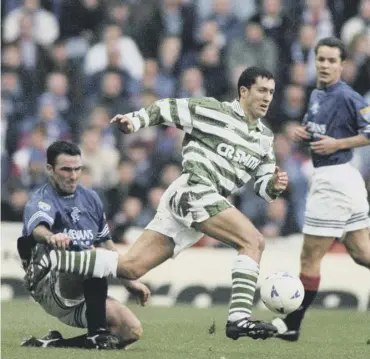  ??  ?? 0 An epic midfield tussle, as John Collins is challenged by Rangers’ Ian Ferguson