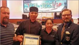  ?? DAN SOKIL — DIGITAL FIRST MEDIA ?? John and Shirley Jiang, chef and owner of Izu Sushi and Asian Fusion in Lansdale, receive the borough’s Business of the Month award from Economic Developmen­t Committee member Mark Ladley, right, and committee Chairman Jason Van Dame, left.