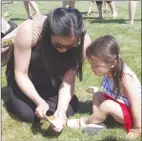  ?? BARB AGUIAR/Special to The Daily Courier ?? Sophia Buvyer and her daughter Sophia, 3, carefully release a Painted Lady butterfly.