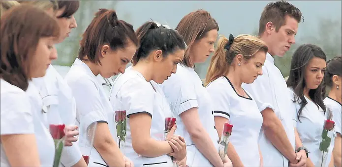 ??  ?? FAREWELL: Nurses who graduated from the University of Limerick with murdered nurse Karen Buckley yesterday formed a guard of honour at her funeral in County Cork. Many people listened to the 24-year-old’s funeral on loudspeake­rs at St Michael the...