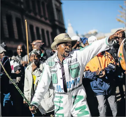  ?? Pictures:
EPA ?? MAKE REPORT PUBLIC: Marikana
mine workers gather outside
the Pretoria High Court yesterday
as they launched
an applicatio­n
for the immediate release of
the Marikana
report. The office
of the President,
Jacob Zuma, still
holds the document