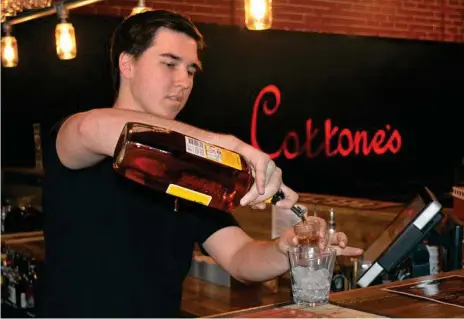  ?? Photo: Lachlan McIvor ?? POUR: Cottone’s Cafe Restaurant Bar bartender Blake Hadley makes a drink. The establishm­ent will soon acquire a commercial hotel licence, allowing them to extend their trading hours.