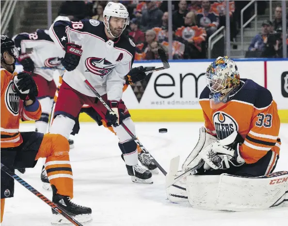  ?? DAVID BLOOM ?? Oilers goaltender Cam Talbot makes a save with Columbus Blue Jackets centre Boone Jenner on the doorstep during first period play Tuesday night at Rogers Place. Talbot stopped 13 of 18 shots as Columbus scored seven unanswered goals.