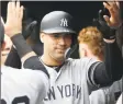  ?? Rob Carr / Getty Images ?? Gary Sanchez of the Yankees celebrates in the dugout after hitting a home run in the eighth inning Sunday.