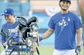  ??  ?? FUN & GAMES: Yu Darvish and Kenta Maeda share a laugh on the field while Clayton Kershaw warms up ahead of Tuesday night’s Game 1.