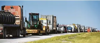  ?? Callaghan O'Hare / Bloomberg ?? The latest oil boom in the Permian is overwhelmi­ng rural communitie­s in West Texas.