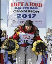  ?? DIANA HAECKER / AP ?? Last year’s Iditarod champion Mitch Seavey poses with his dogs. His son, Dallas, was involved in a doping scandal after the race. Four of Dallas’ dogs tested positive for tramadol, an opioid pain reliever.