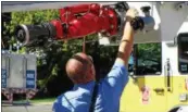  ?? JOHN BREWER — ONEIDA DAILY DISPATCH ?? Oneida City firefighte­rs check out the squirter on the 2016“Squirt” engine.