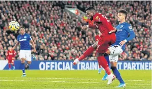  ?? REUTERS ?? Liverpool’s Divock Origi scores his team’s third goal against Everton at Anfield.