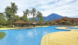  ??  ?? The resort’s massive 340- ft.- long pool with a view of the mountains on one side and the beach on the other.