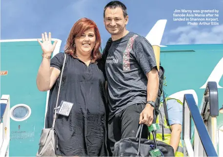  ??  ?? Jim Warny was greeted by fiancée Asia Mania after he landed in Shannon Airport. Photo: Arthur Ellis