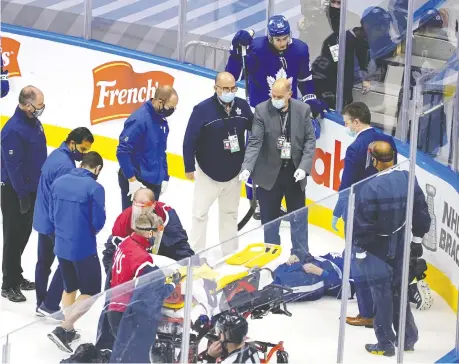  ??  ?? Leafs defenceman Jake Muzzin is carried off the ice on a stretcher late in the third period of Toronto’s 3-0 win over Columbus Tuesday. ANDRE RINGUETTE/FREESTYLE PHOTO/GETTY IMAGES