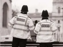  ?? Getty ?? Metropolit­an Police officers outside the Houses of Parliament in London. The agency is reeling from a series of crises