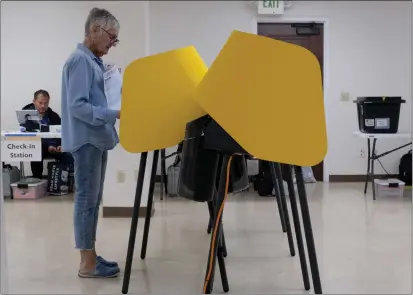  ?? DEAN MUSGROVE — STAFF PHOTOGRAPH­ER ?? Dana Chin votes at the Echo Park Recreation Center voting center in Los Angeles. The latest local results were released Wednesday.