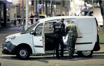  ?? ARIE KIEVIT/GETTY IMAGES ?? Police search a van with gas canisters in the vicinity of the concert venue Maassilo, after a concert was cancelled because of a terror threat, in Rotterdam, Netherland­s, Wednesday night.