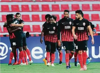  ?? Ahmed Ramzan/Gulf News ?? Al Ahli FC players celebrate after scoring against Iran’s Esteghlal during the AFC Champions League match at Al Rashid Stadium. Cosmin Olaroiu’s men won 2-1.