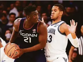  ?? Tim Nwachukwu / Getty Images ?? UConn’s Adama Sanogo (21) could be going up against Villanova’s Eric Dixon three times in the regular season alone in 2022-23.