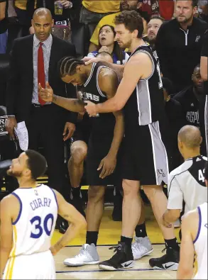  ?? Associated Press ?? San Antonio Spurs forward Kawhi Leonard, center left, was ruled out of today’s Game 2 of the Western Conference finals against Golden State. Leonard re-sprained his left ankle in Game 1 on Sunday.