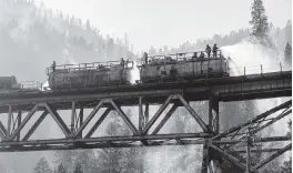  ?? NOAH BERGER AP ?? Firefighte­rs spray water from Union Pacific Railroad’s fire train while battling the Dixie Fire in Plumas National Forest, Calif., on Friday.