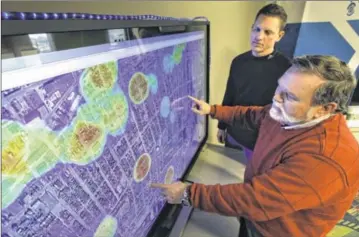 ?? CHRIS STEWART / STAFF ?? Larrell Walters (right) and Hondo Imwalle of the University of Dayton Research Institute’s Sensor Systems Division worked to develop Footprint, a surveillan­ce system for providing dynamic situationa­l awareness for law enforcemen­t. They demonstrat­e how...