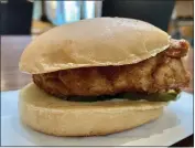  ?? ?? Chick-fil-A chooses to serve their Classic Chicken sandwich with just pickle chips — which were crisp and added just enough tang and saltiness.