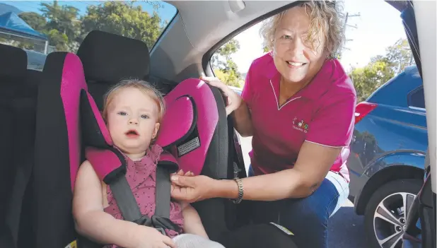  ?? Picture: ANNA ROGERS ?? TUCKED IN: Kidsafe Queensland chief executive Susan Teerds checks the child seat of Willow Van der Spek, 2, in Cairns yesterday.