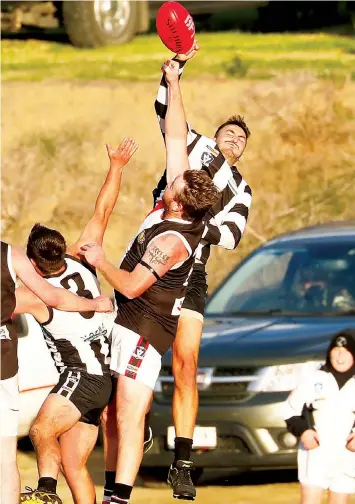  ?? Photograph­s Jeff Tull ?? Alex Doria leaps over his Nyora opponent on Saturday. Doria was named in Poowong’s best.