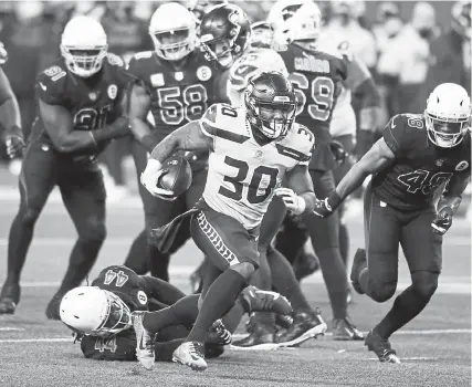  ?? Lindsey Wasson, The Associated Press ?? Seattle Seahawks running back Carlos Hyde rushes against the Arizona Cardinals during the first half on Thursday night in Seattle.