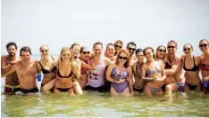  ??  ?? Above, from left: Karlie (far right) at Taylor Swift’s Fourth of July party, with guests including Cara Delevingne, Tom Hiddleston, Blake Lively, Ryan Reynolds and Gigi Hadid; water fun with Taylor and together on the Victoria’s Secret catwalk