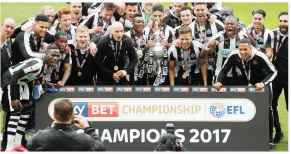  ??  ?? Newcastle celebrates after winning the league with the trophy on Sunday. (Reuters)