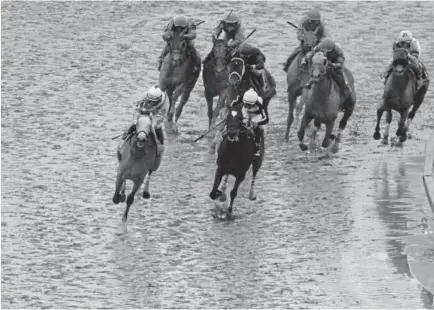  ?? Rob Carr, Getty Images ?? Jockey Paco Lopez, left, rides Red Ruby to victory in the 94th running of the Black-Eyed Susan Stakes at Pimlico Race Course on Friday. On Saturday, Pimlico plays host to the Preakness Stakes, the second jewel of the Triple Crown.