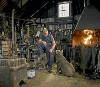  ?? PHOTO: ALDEN WILLIAMS/STUFF ?? Retired blacksmith Les Schenkel with his dog Anzac at the restored smithy at Teddington, Lyttelton. Tourists and locals, the ‘‘whole league of nations’’, often stop in to watch him work, fascinated by the old practices and hard graft.