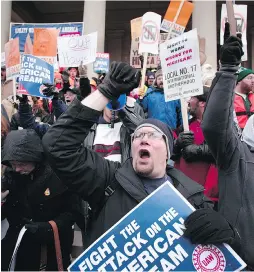  ?? BILL PUGLIANO / GETTY IMAGES FILES ?? Union members rally at the Michigan State Capitol to protest a vote on right-to-work legislatio­n in 2012.