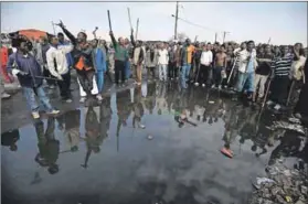  ?? Photo: Paul Botes ?? Xenophobia: People gather to chase non-south Africans out of their settlement.