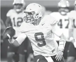  ?? Gerald Herbert/Associated Press ?? ■ LSU quarterbac­k Joe Burrow (9) runs through drills during their NCAA college football practice Monday in Baton Rouge, La. The former Ohio State quarterbac­k played behind the dynamic J.T. Barrett for two seasons. Burrow will compete for a starting job...