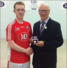  ??  ?? Willie Roche GAA Handball president presents Hardball All-Ireland Intermedia­te Singles medal to Daniel Relihan, Liscarroll following his win over Tipperary’s David Moloney in the final at Thurles.